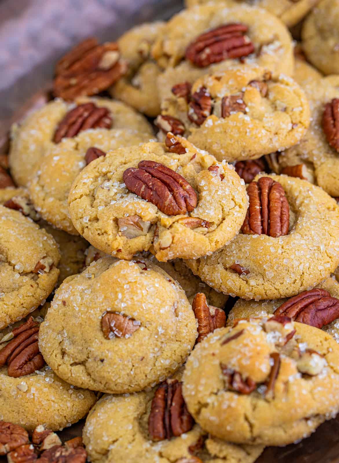 Stacked Butter Pecan Cookies on hammered metal tray.