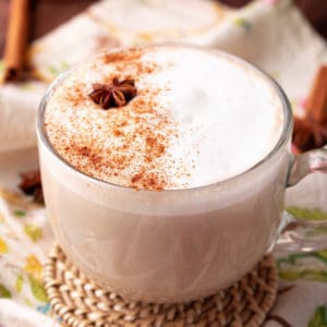 Square image of Chai Latte in mug with cinnamon and a star of anise.