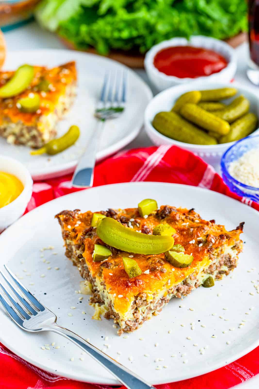 Slice of Cheeseburger Pie on white plate with fork.
