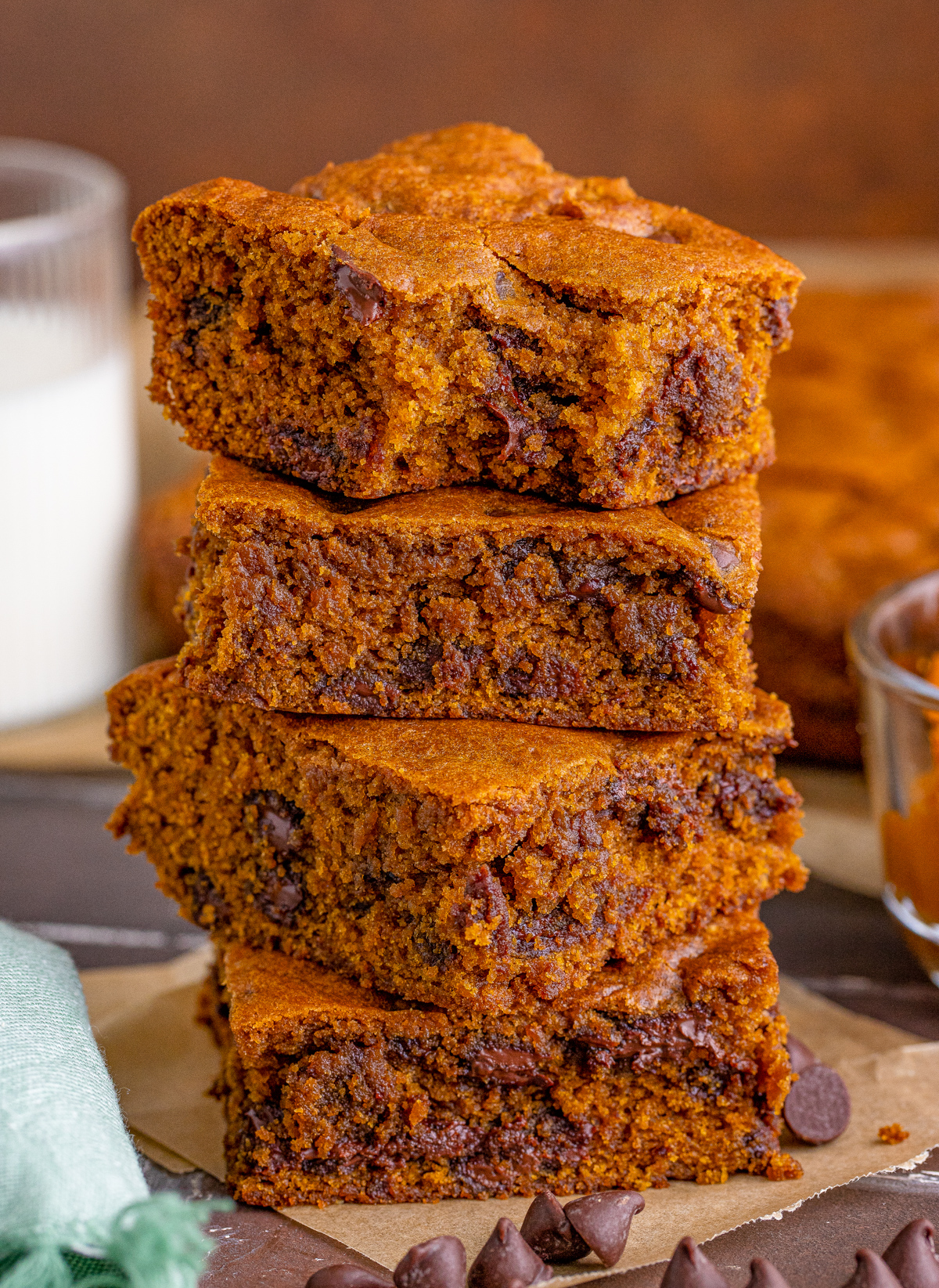 Four stacked Chocolate Chip Pumpkin Blondies with bite taken out of top one.