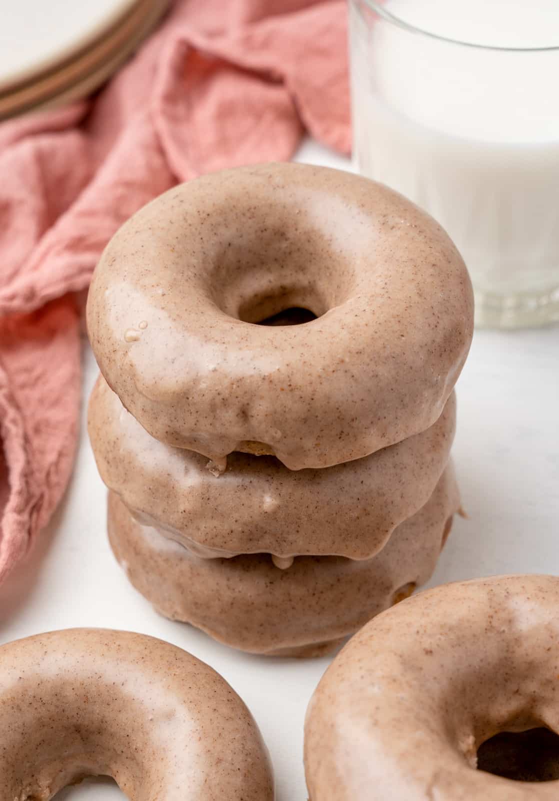 Three stacked Glazed Apple Cider Donuts.