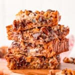 Square image of four stacked Hello Dolly Bars showing gooey center.