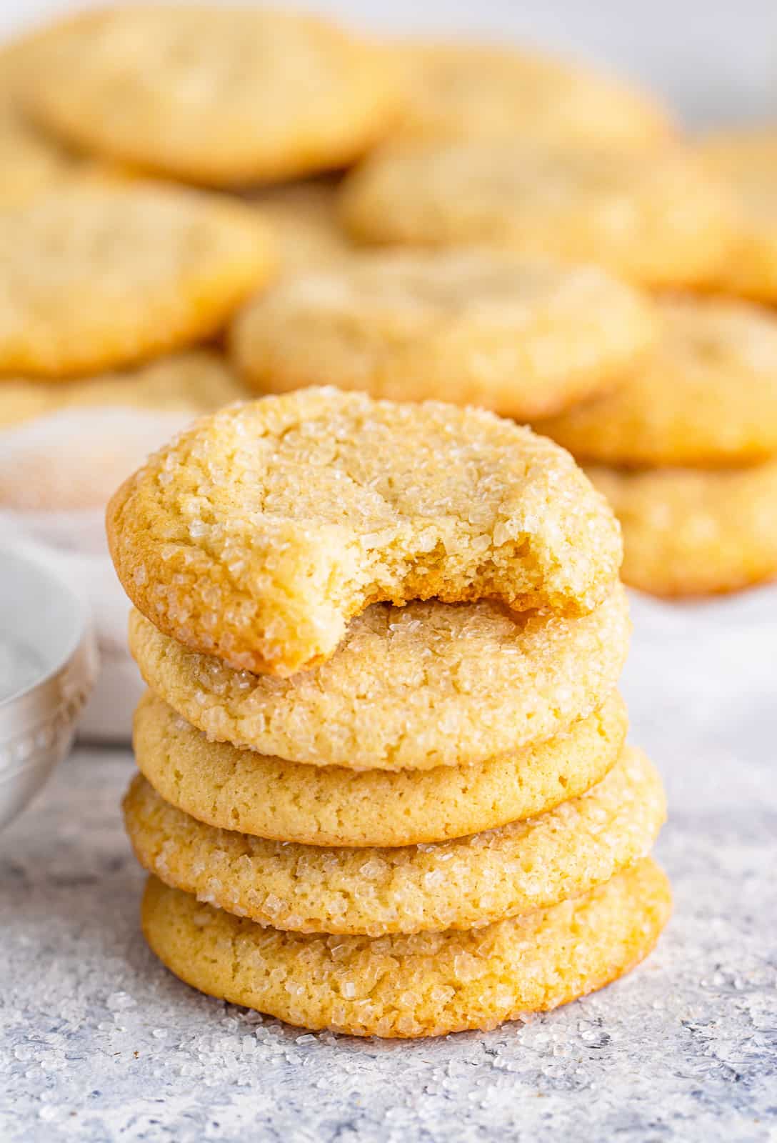 Five stacked Chewy Sugar Cookies with bite taken out of top cookie.