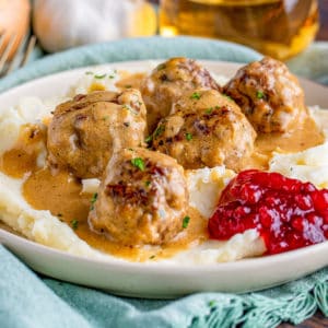 Square image close up of Swedish Meatballs over mashed potatoes.
