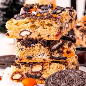 Close up of three stacked bars on top of one another with Oreos and M&Ms around them.