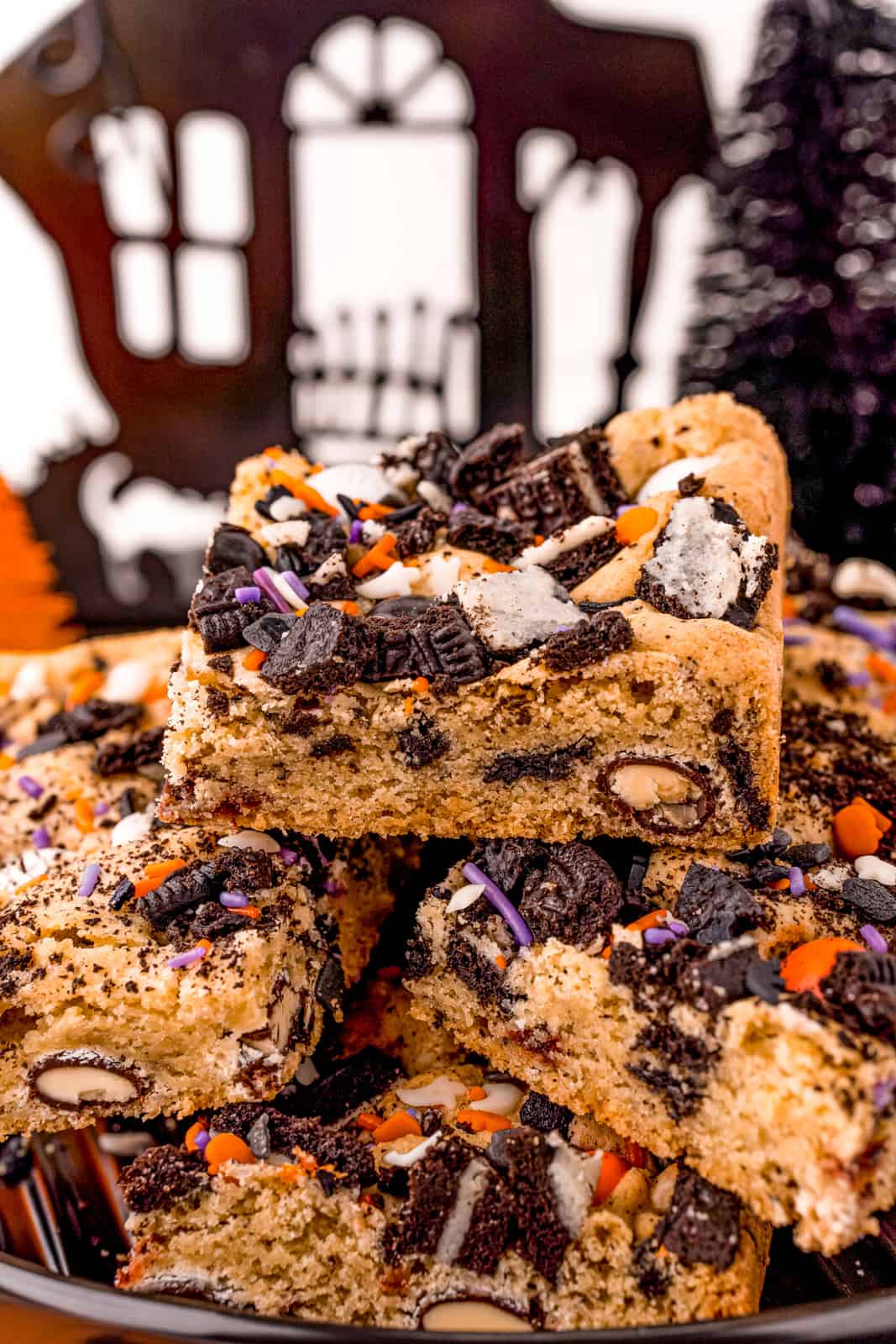 Close up side view of stacked Halloween Cookie Bars. 