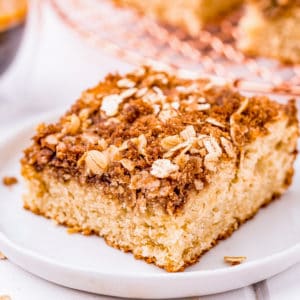 Square image of slice of Coffee Cake on white plate.