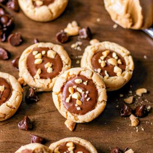 Square image of three Cookie Cups with chopped peanuts.