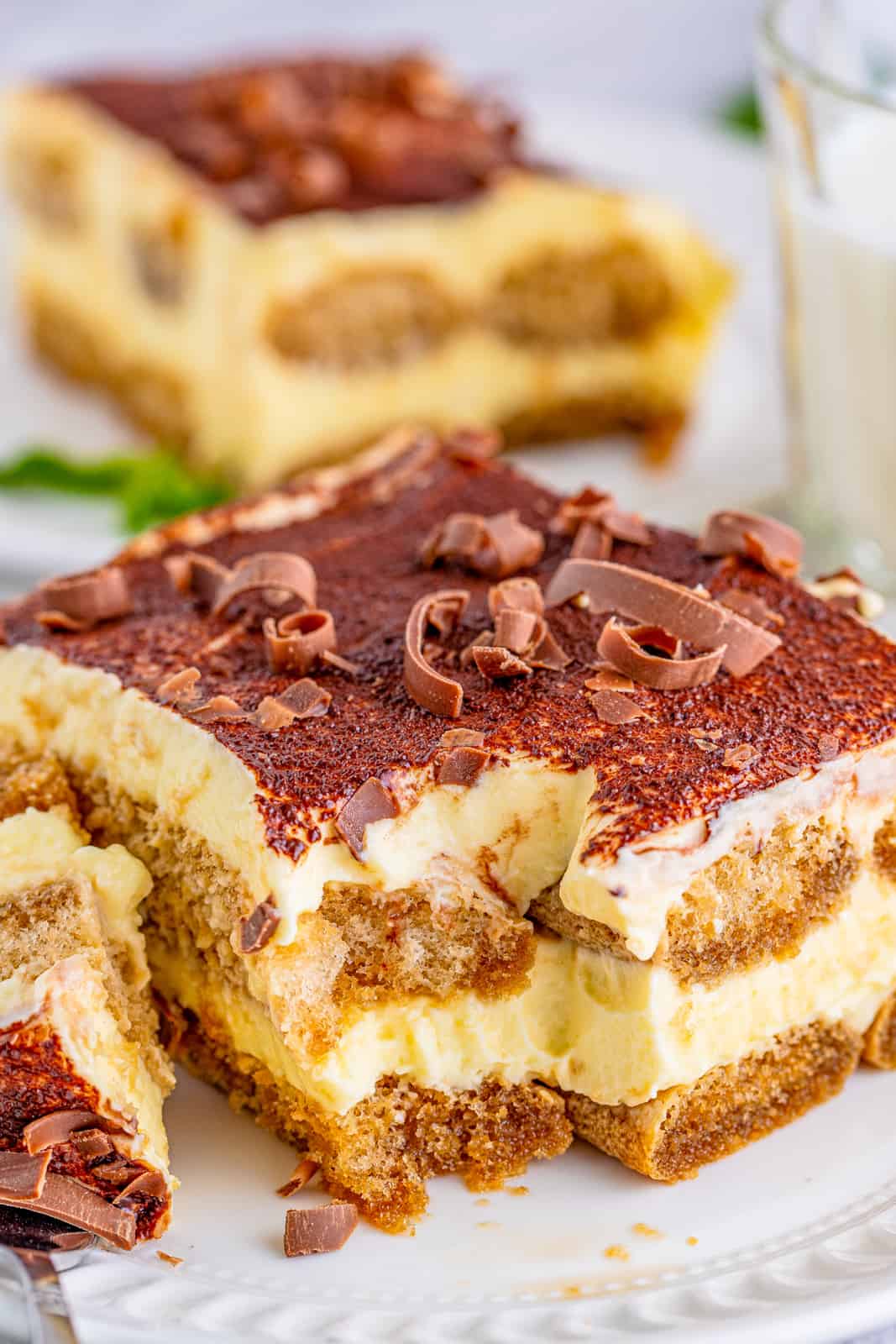 The Best Tiramisu Recipe slice on plate with bite taken out of it.