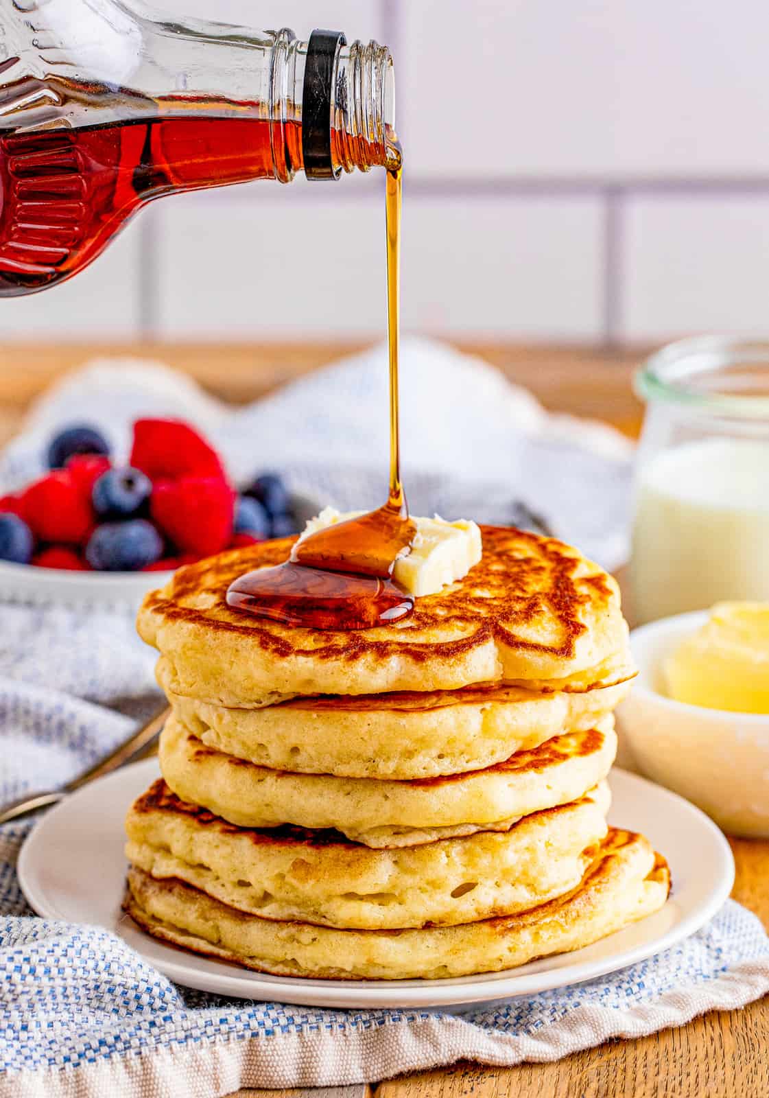 Syrup being drizzled over stack of the Buttermilk Pancake Recipe.