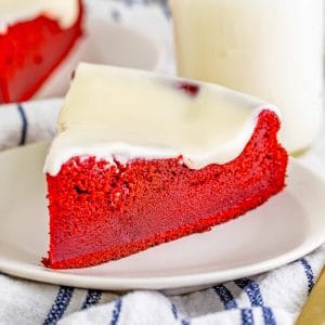 Square image of a slice of Red Velvet Ricotta Cake on white plate.