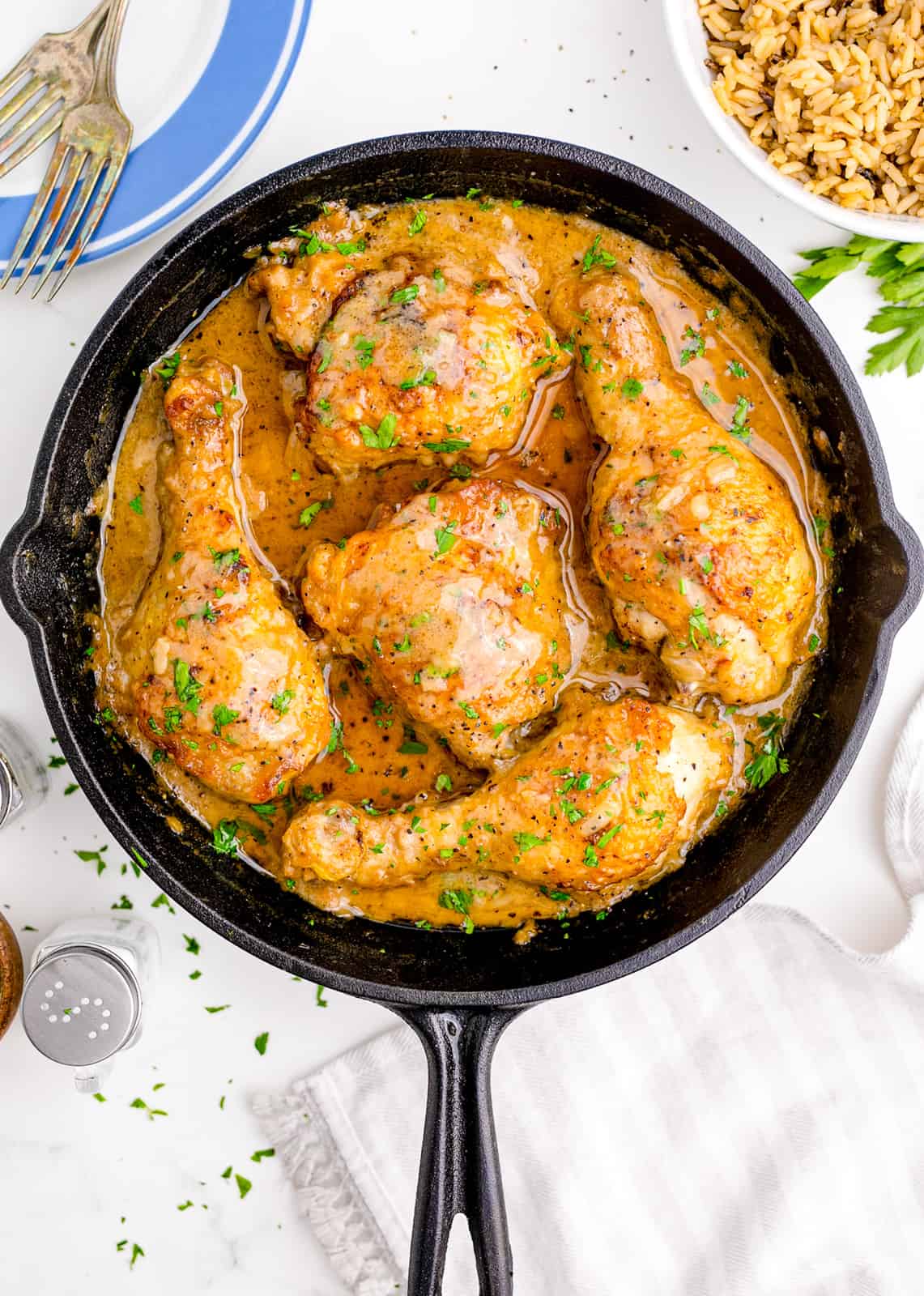 Overhead photo of Smothered Chicken in cast iron skillet.