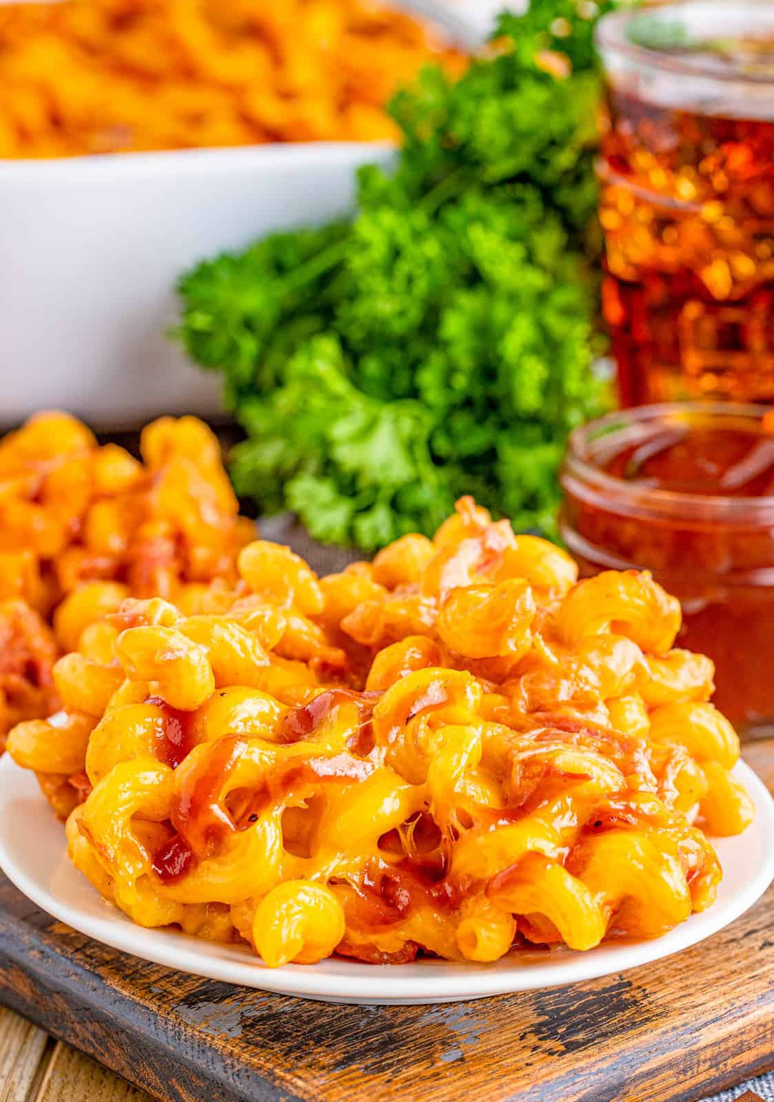 Close up of plate of Pulled Pork Mac and Cheese showing the pork and bbq sauce.