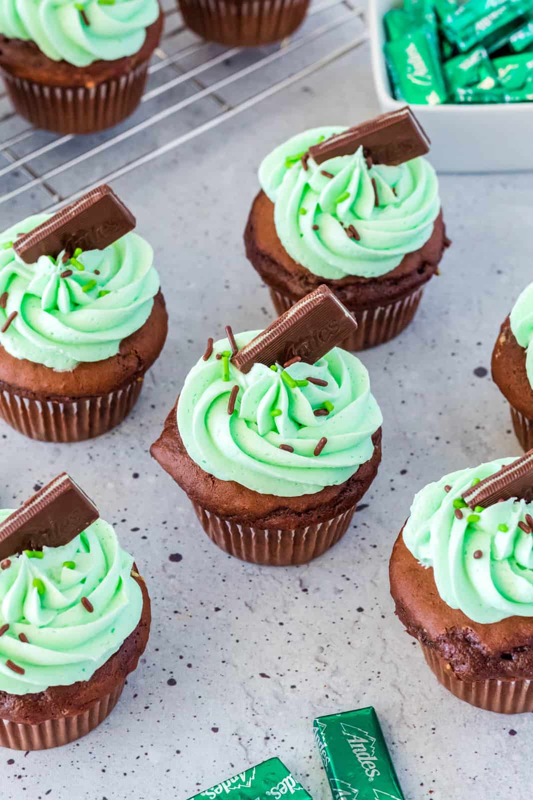 Mint Chocolate Cupcakes spread out topped with Andes mints.