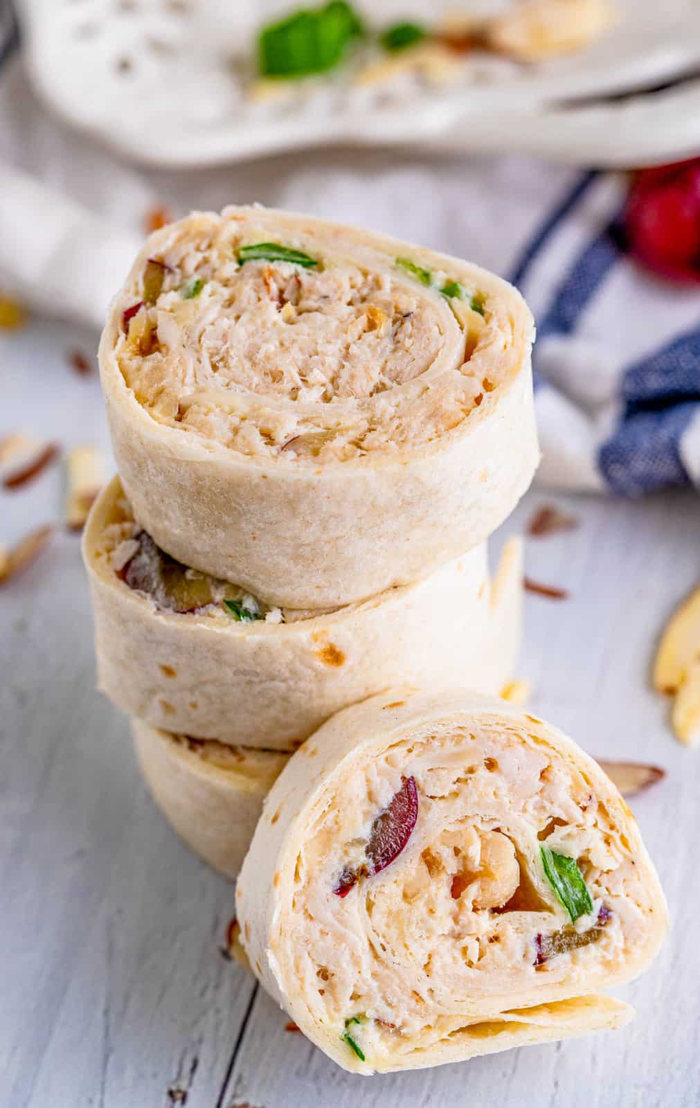 Stacked Chicken Salad Pinwheels with one laying propped up next to it.