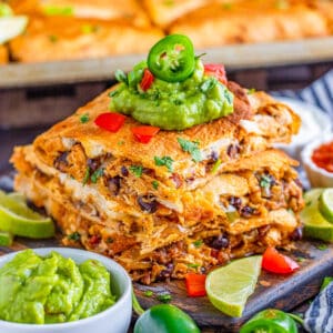 Square image of quesadillas stacked with toppings.
