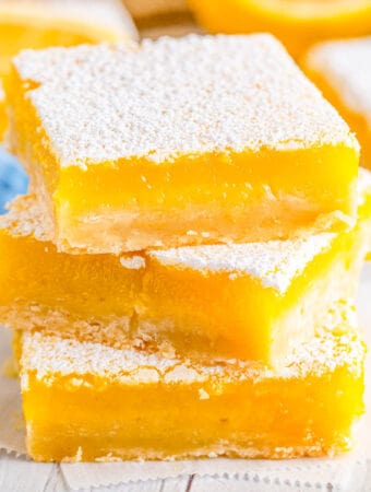 Square image of three stacked Lemon Bars.