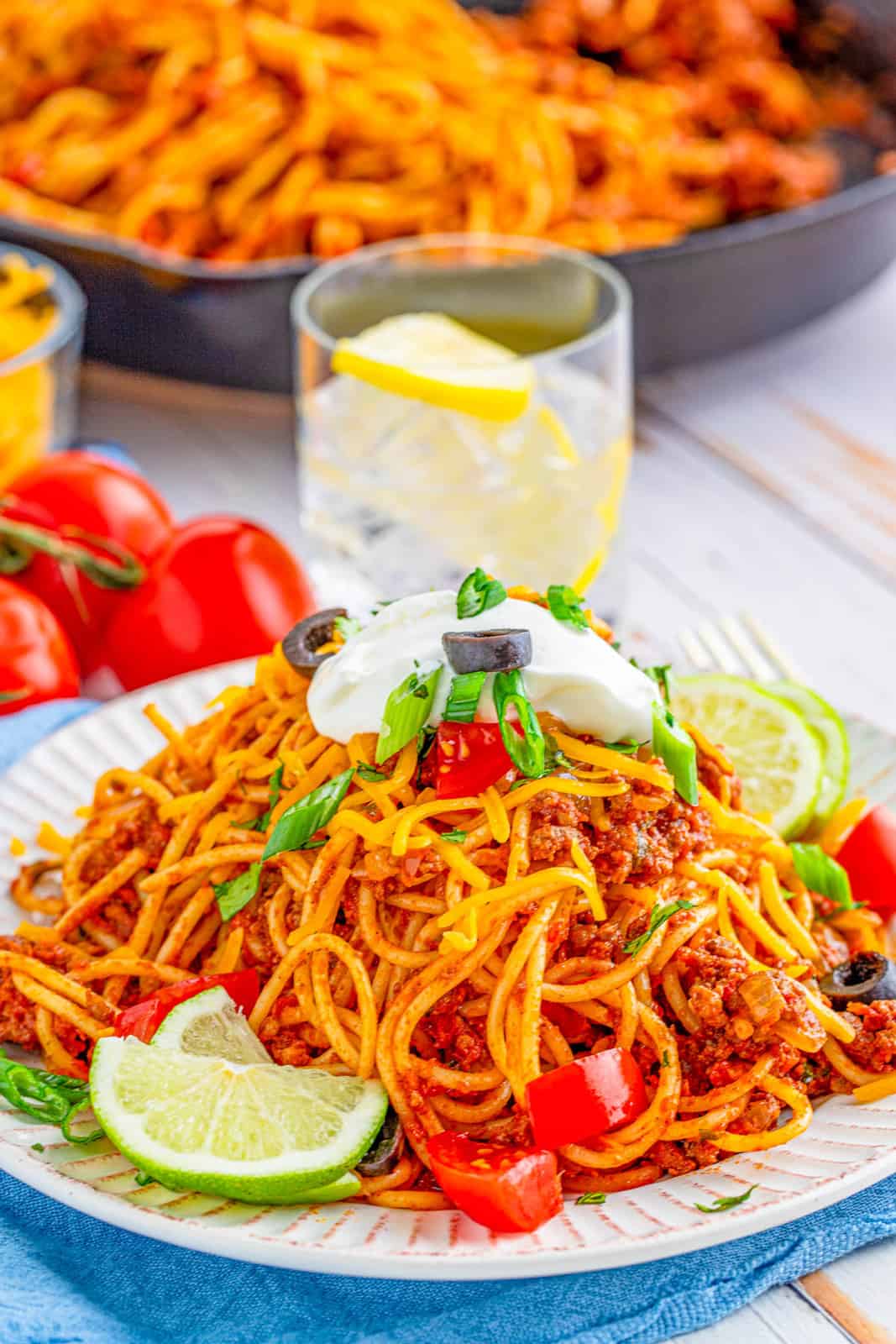 Taco Spaghetti on white plate topped with taco toppings.