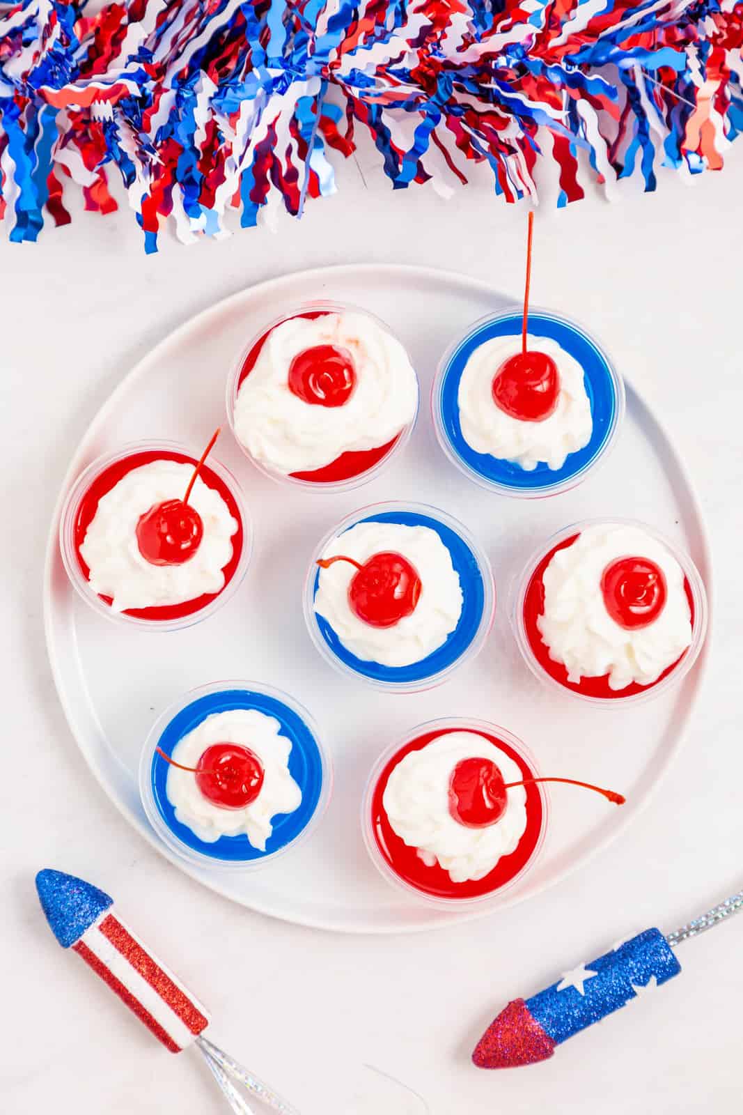 Overhead of finished 4th of July Jello Shots on white plate.