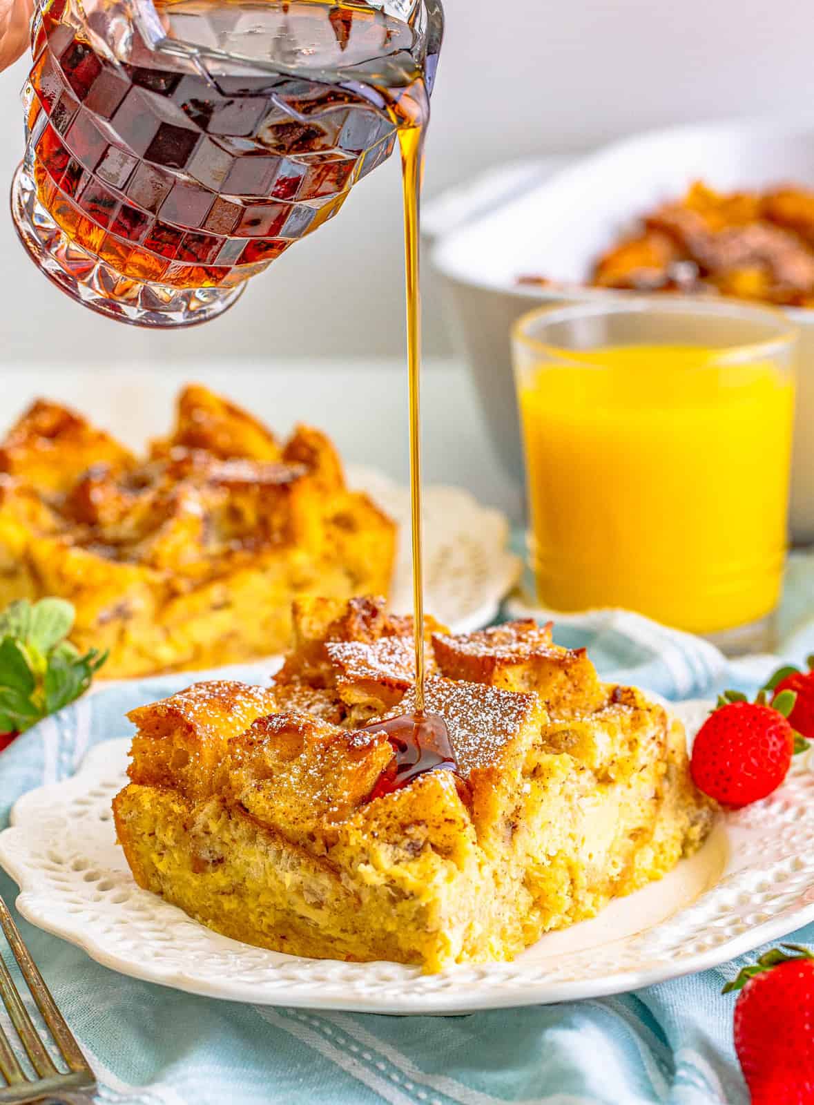 Syrup being poured over a slice of French Toast Casserole.