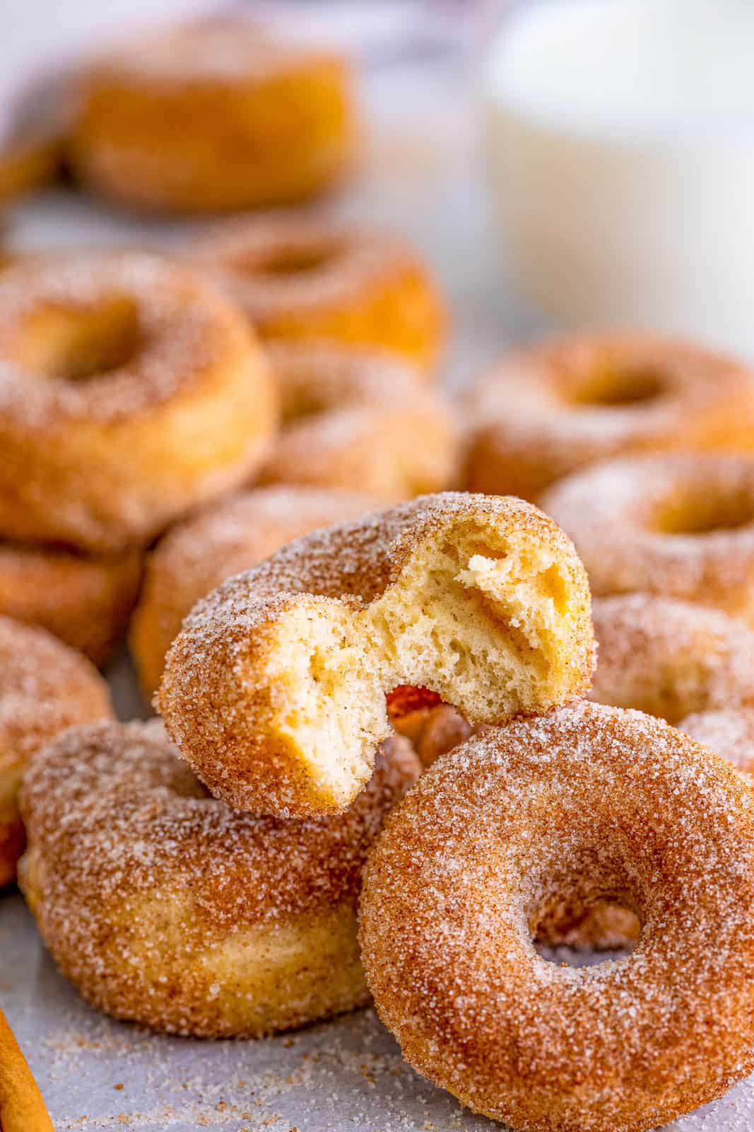 Layered Cinnamon Sugar Mini Donuts with bite taken out of one.