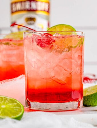 Square image of finished cocktail garnished with limes around glass.