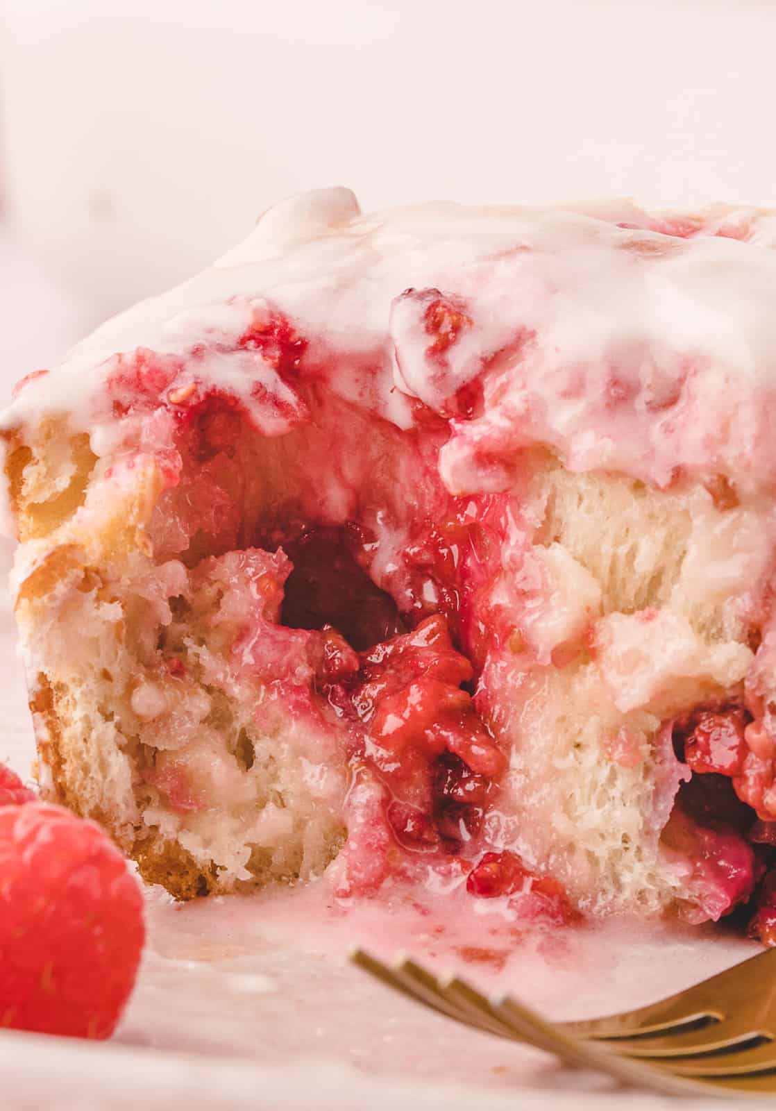 Close up of inside of one of the Raspberry Sweet Rolls showing the raspberries.