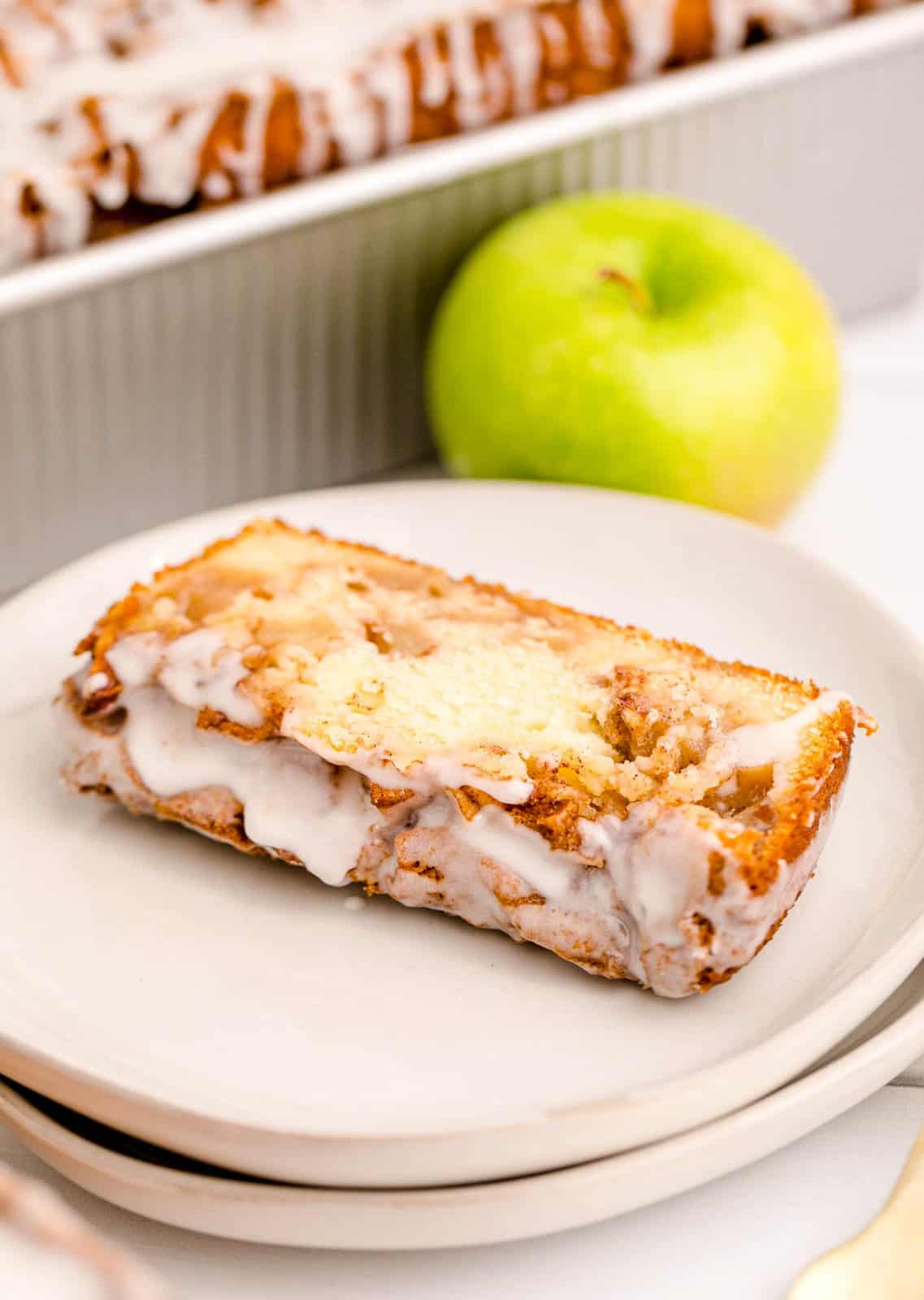 Once slice of Apple Fritter Bread on white plate.