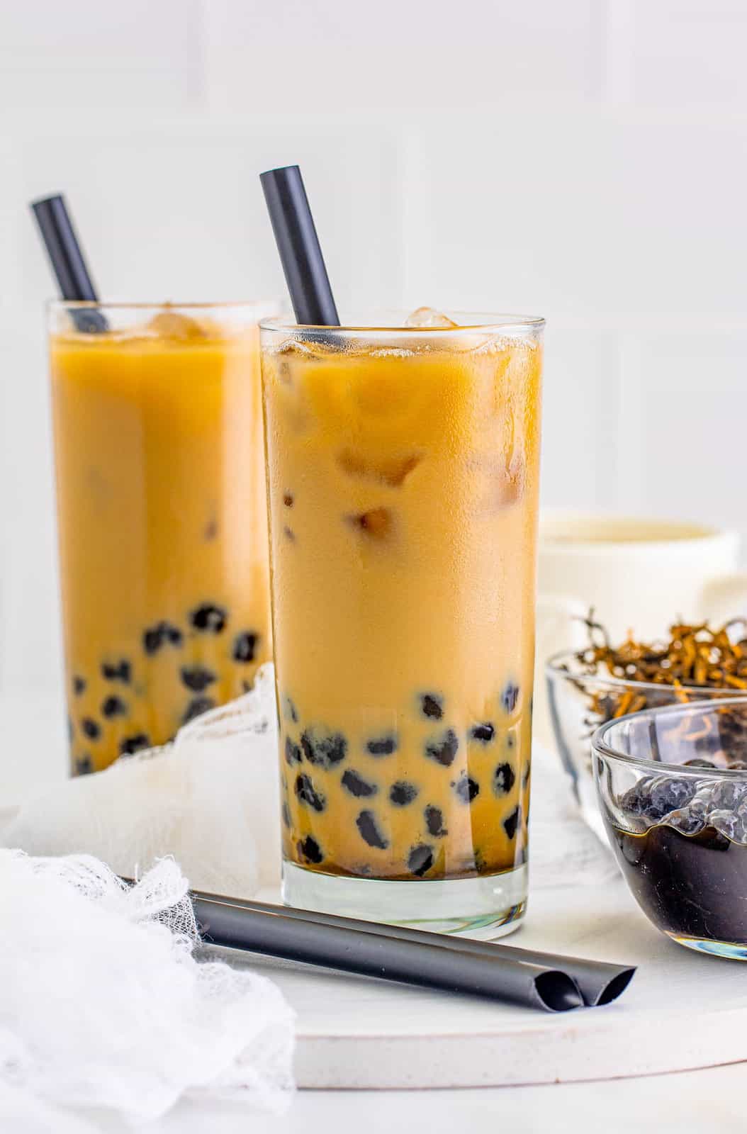 Two glasses of the Bubble Tea Recipe with straws.