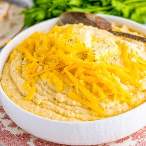 Square image of Grits in bowl with cheese and butter.