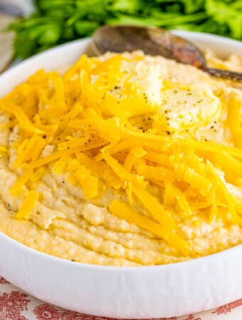 Square image of Grits in bowl with cheese and butter.