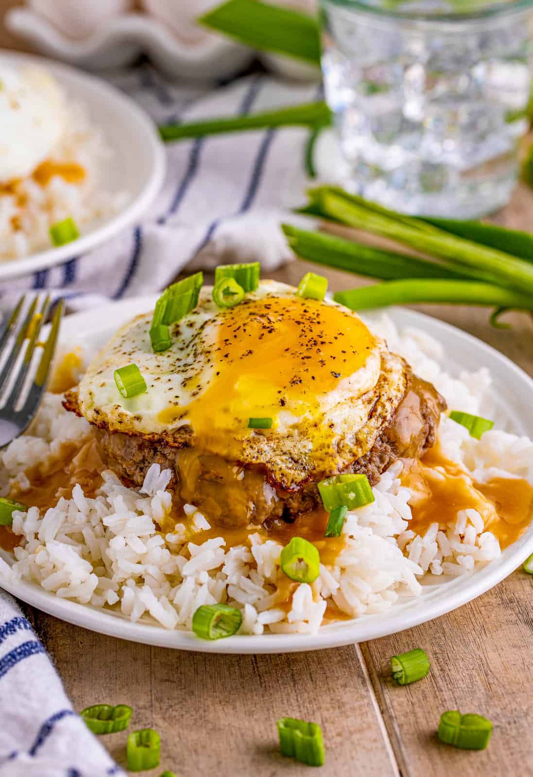 Loco Moco Recipe over rice with yolk running out of egg on top.