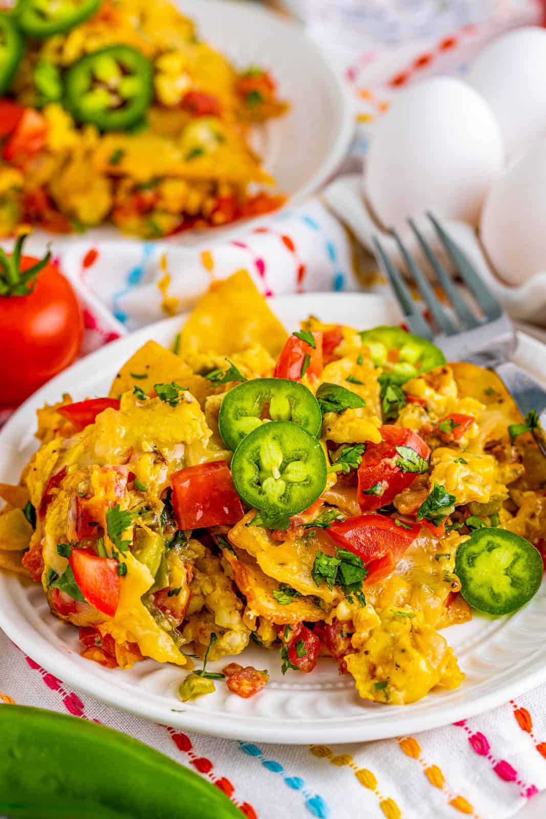 Migas Recipe on white plate topped with jalapenos.