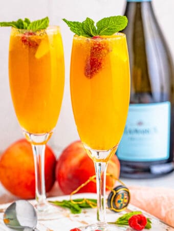 Square image of Bellinis in two glasses.