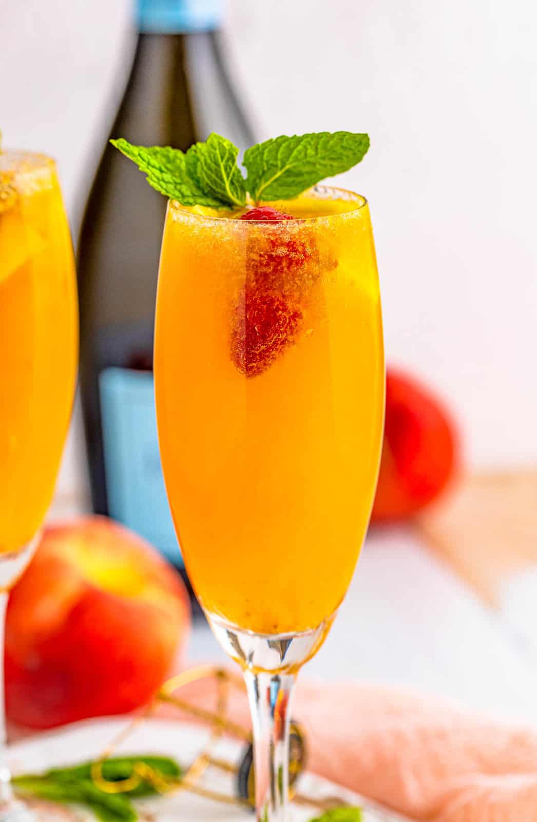 Close up of one Peach Bellini Showing the raspberry and mint.