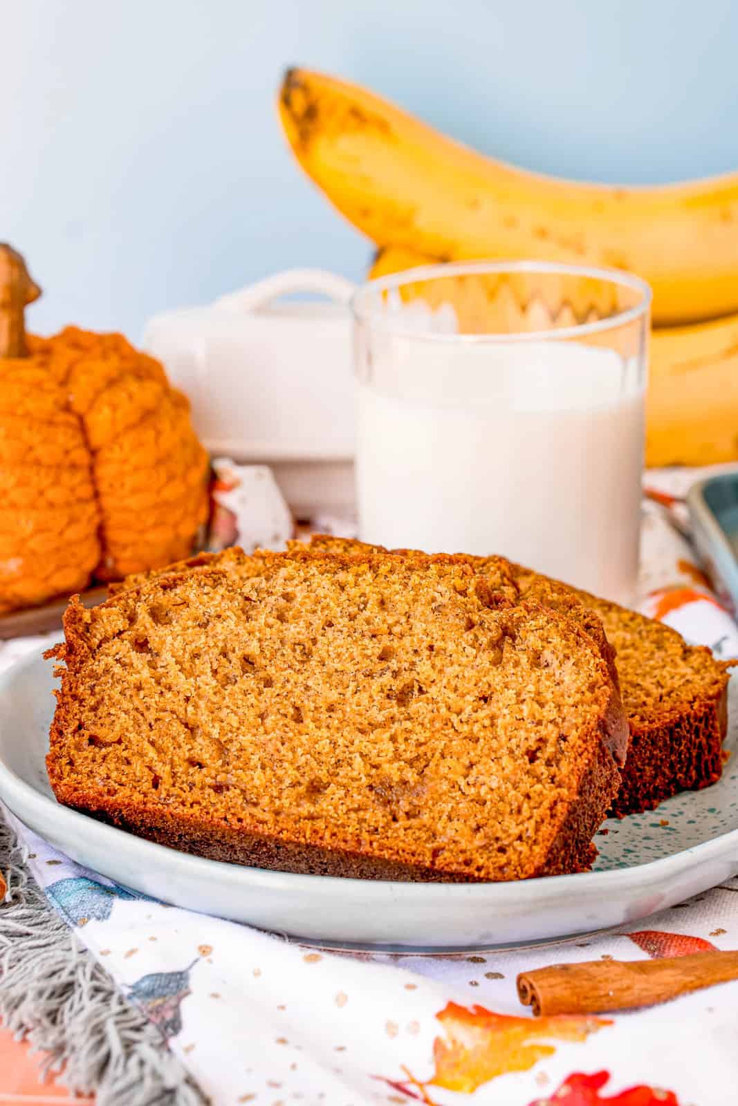 Pumpkin Banana Bread on plate with one slice propped up.