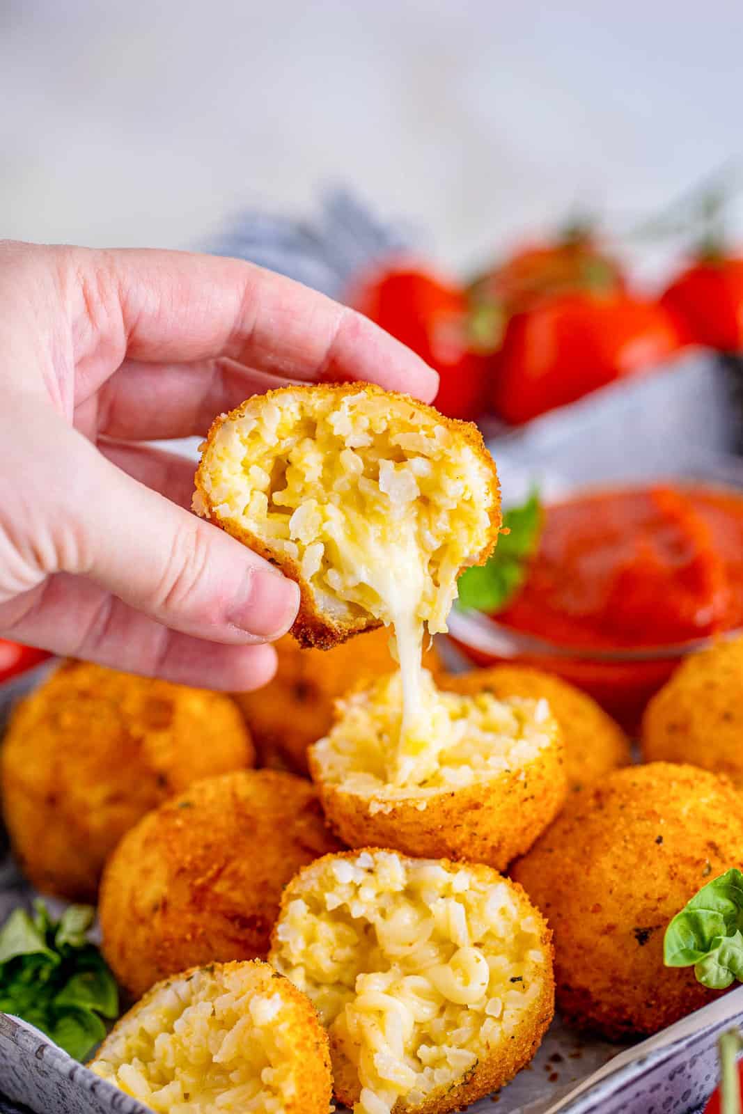 One open Arancini showing a cheese pull.