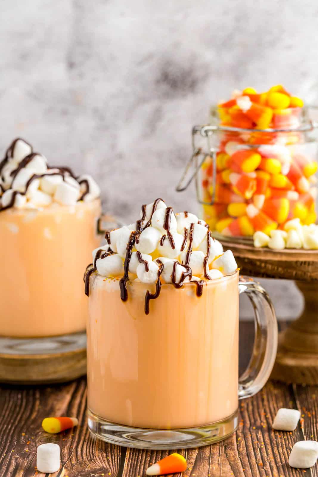 Candy Corn Hot Chocolate in mug with marshmallows drizzled with chocolate.