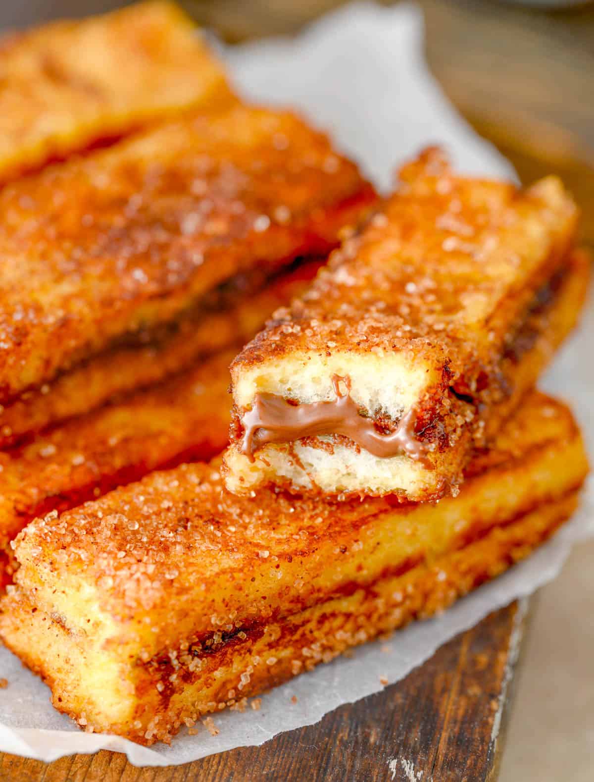 Layered Nutella French Toast Sticks with bite taken out of one.