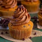 Square image of one of the Pumpkin Chocolate Chip Cupcakes on burlap.