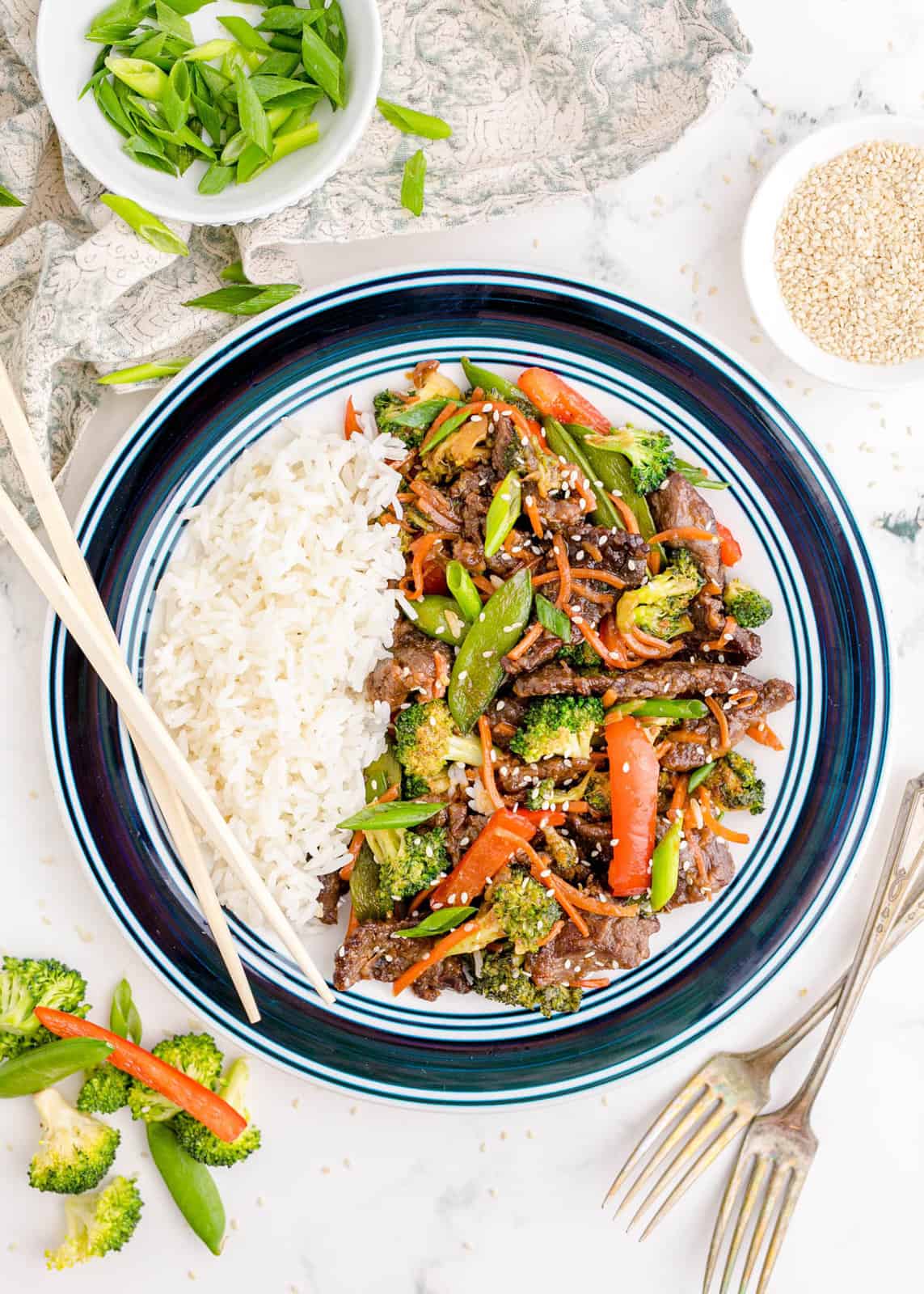 Overhead of Easy Beef Stir Fry on plate with rice and chopsticks.