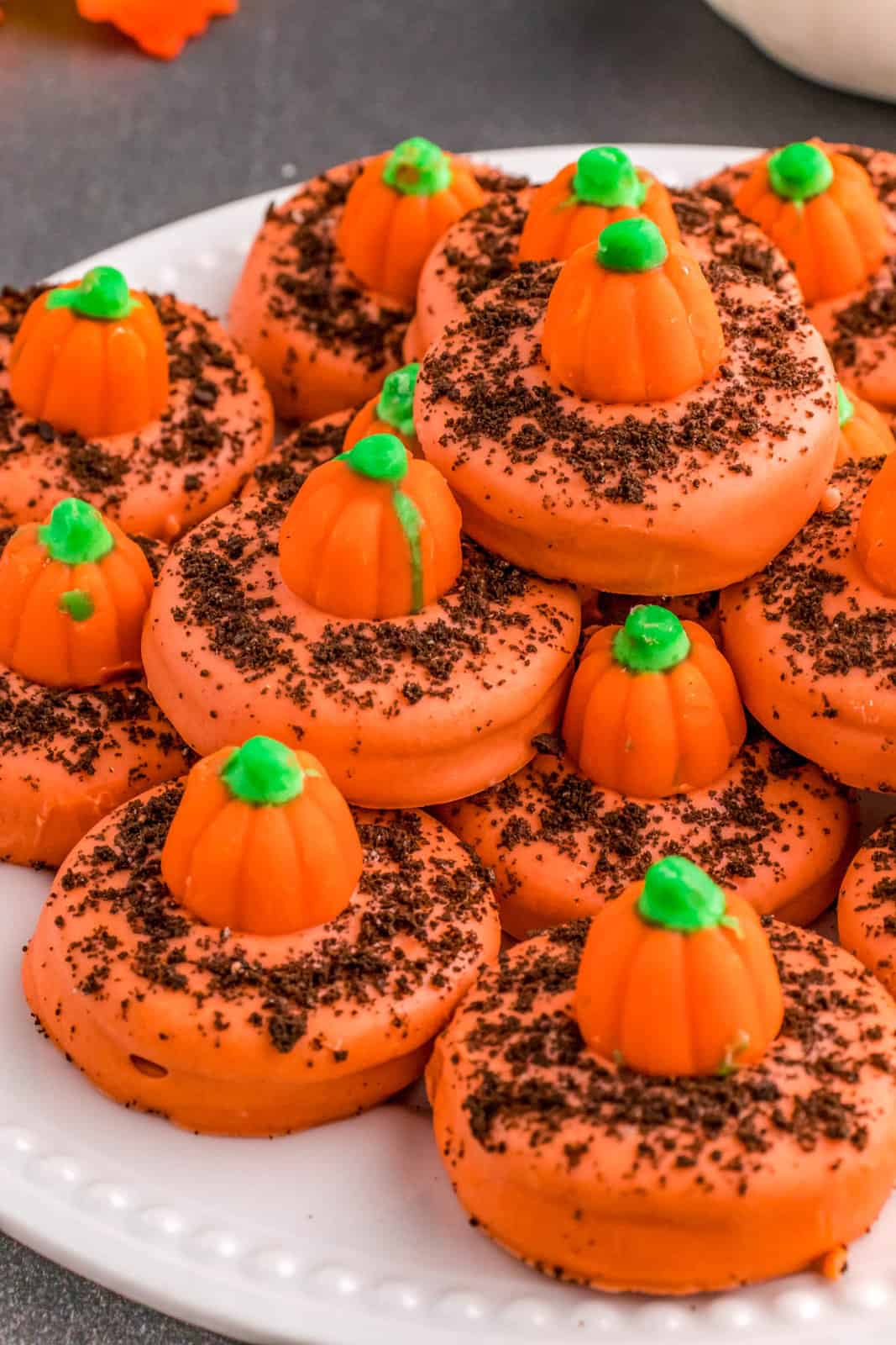 Stacked Pumpkin Patch Cookies on white plate.