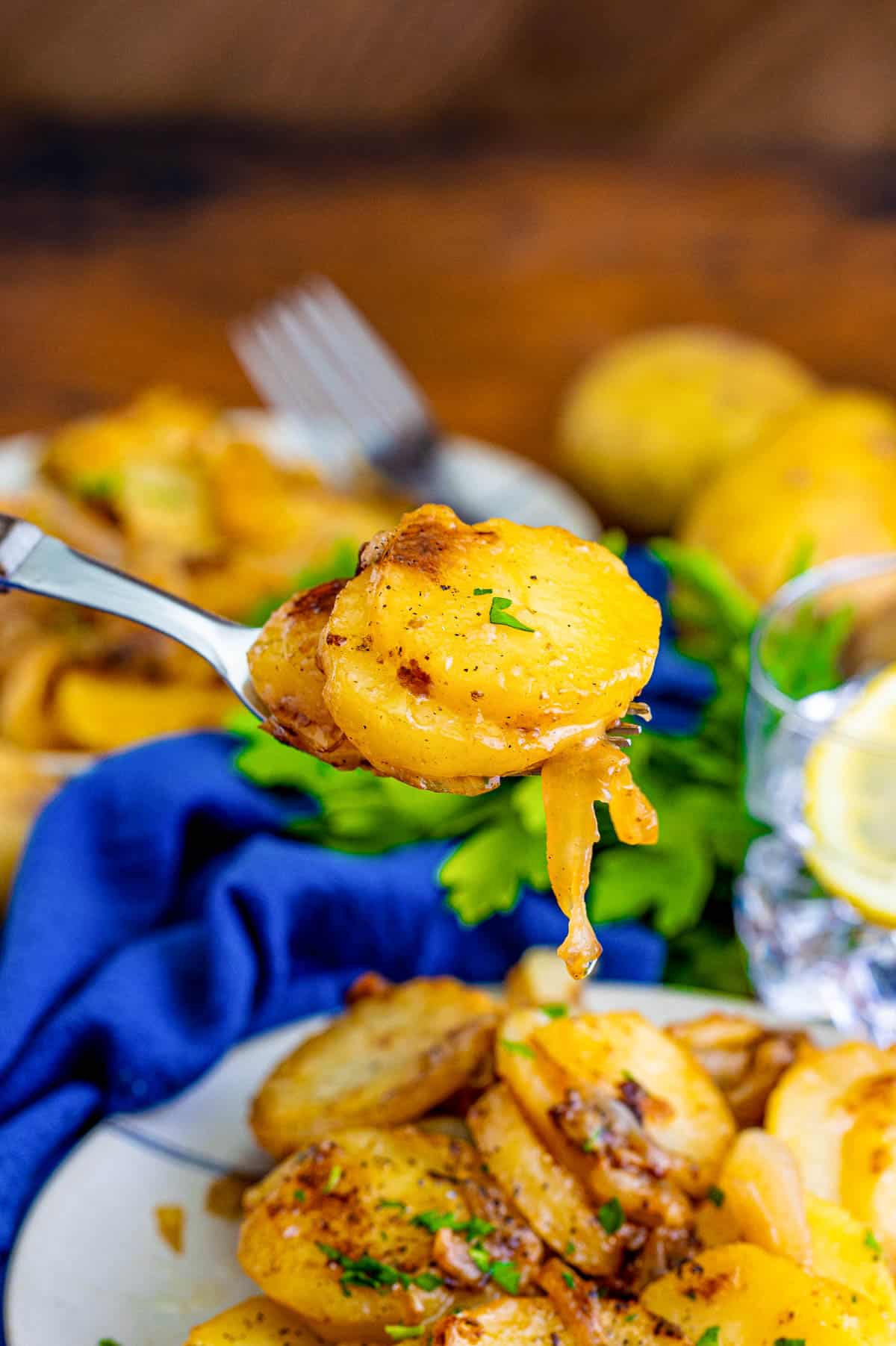 Fork holding up a bite of potatoes.