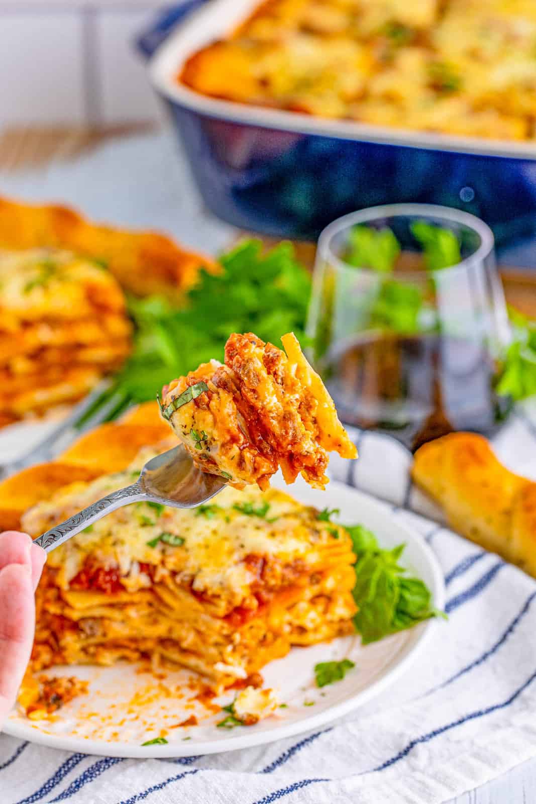 Fork holding up a bite out of the lasagna.