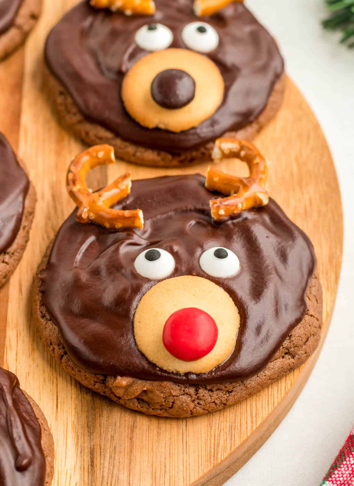 Close up of one finished Reindeer Cookies on wooden board.