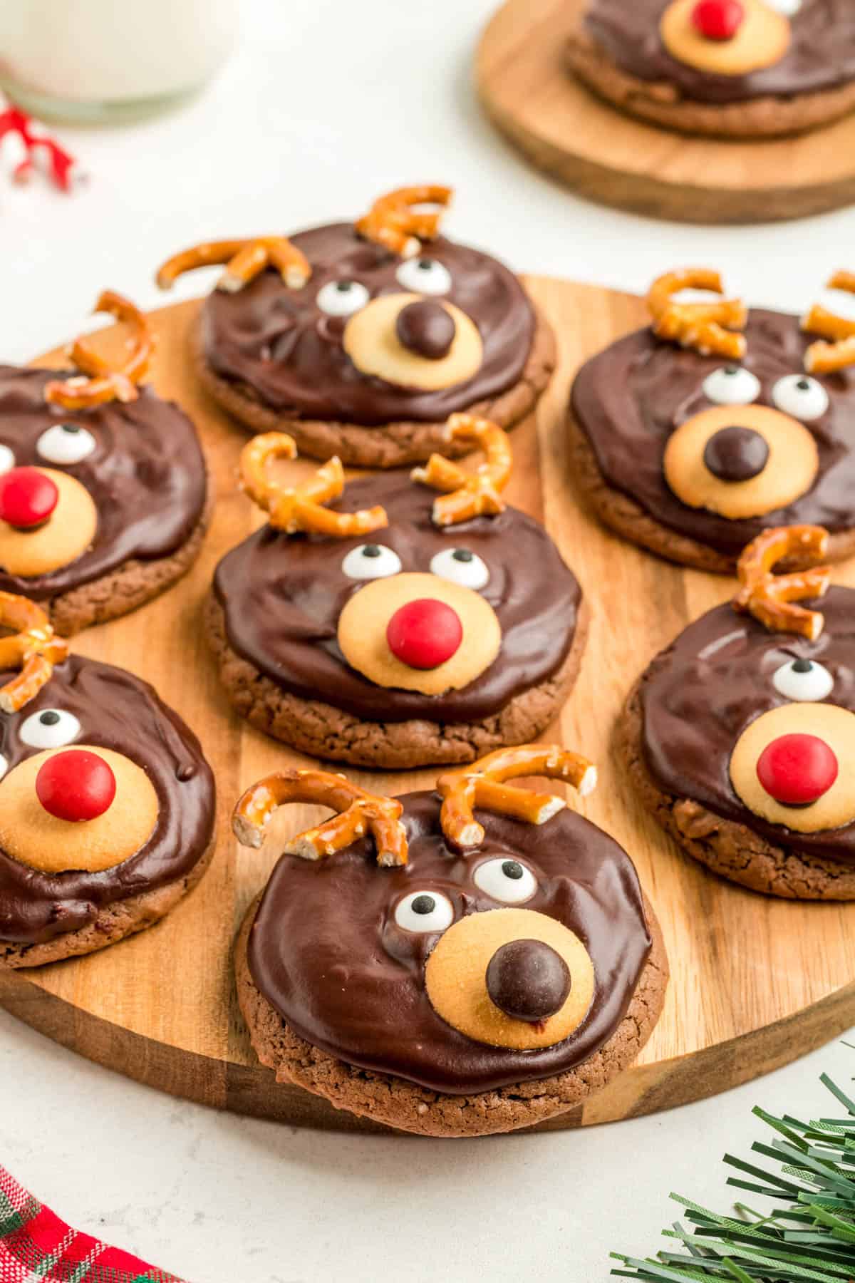Reindeer Cookies decorated on wooden board.