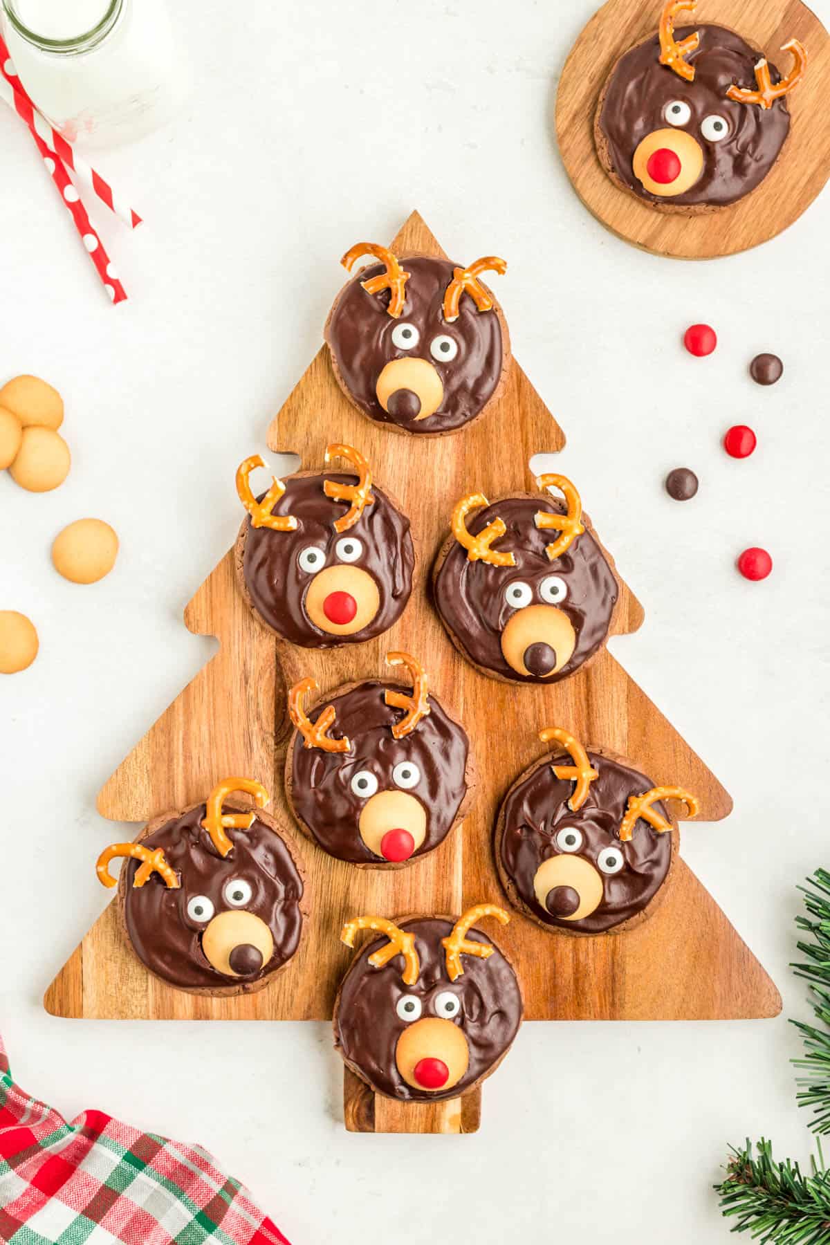 Overhead of finished Reindeer Cookies on christmas tree wooden board.