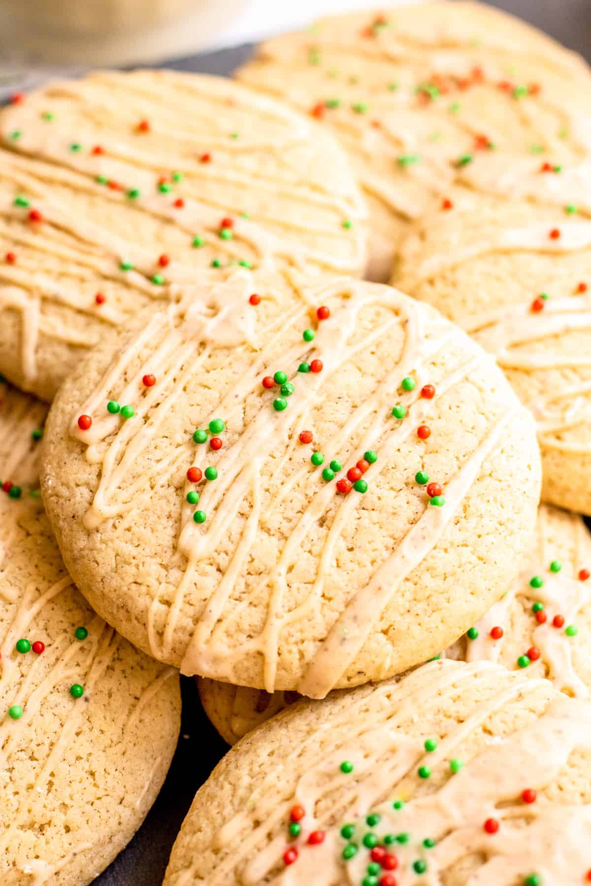Stacked Eggnog Cookies on top of one another on slate.
