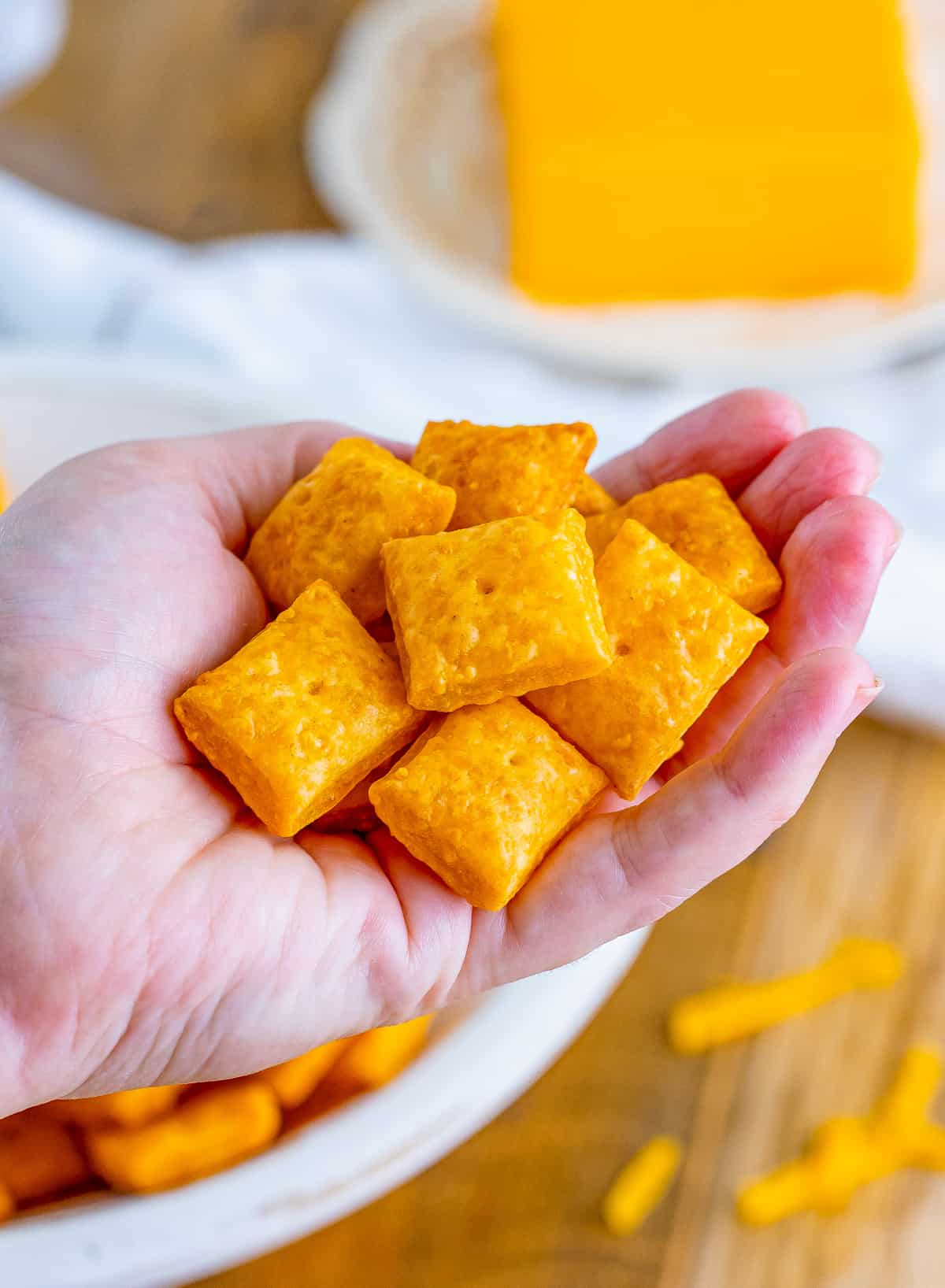 Hand holding a handful of the Homemade Cheez-Its.