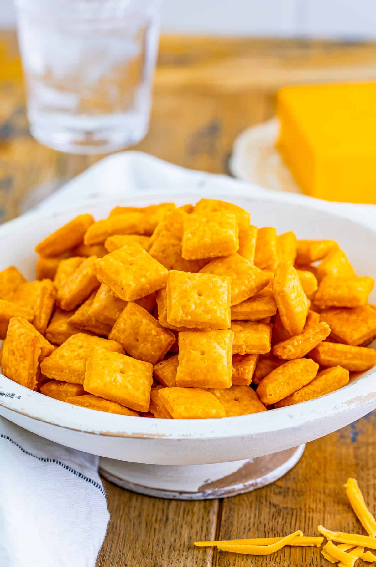 Homemade Cheez-Its in white wooden bowl.